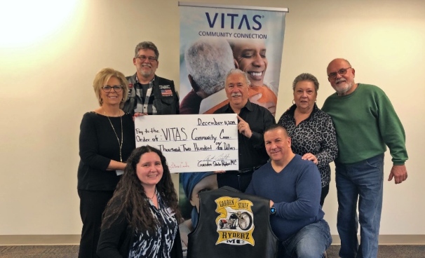 The group presents the ceremonial check to VITAS Community Connection
