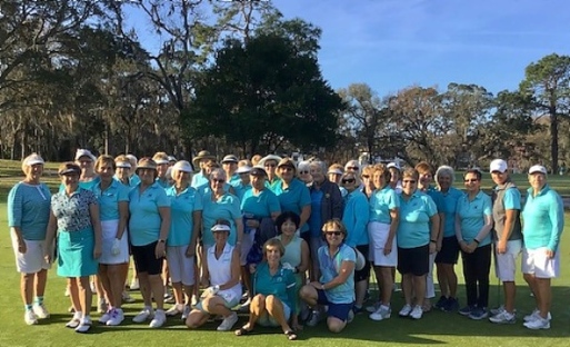 The golfers gather for a group photo on the course